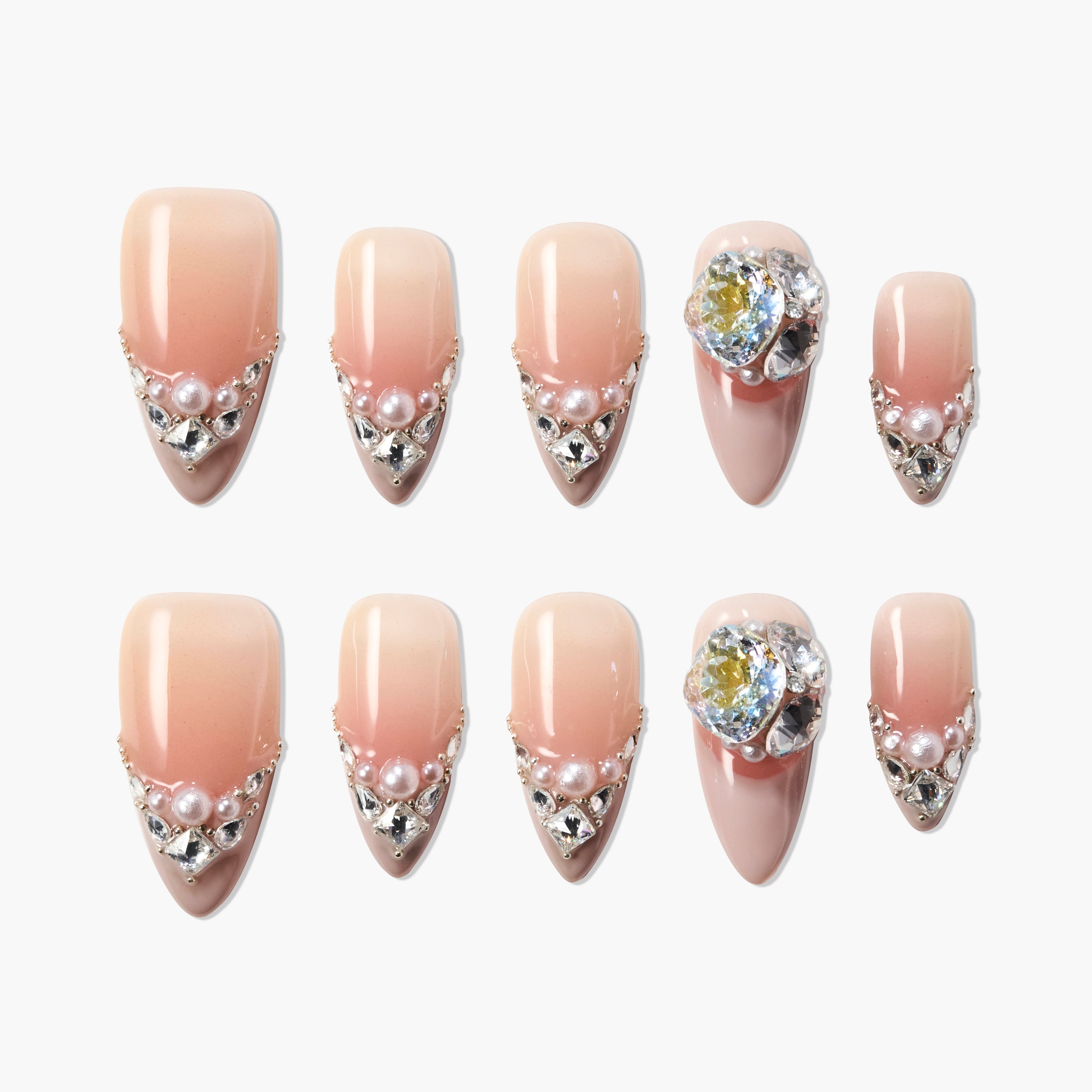Handmade press-on nails in nude pink ombre with pearls, rhinestones, and 3D crystal accents
