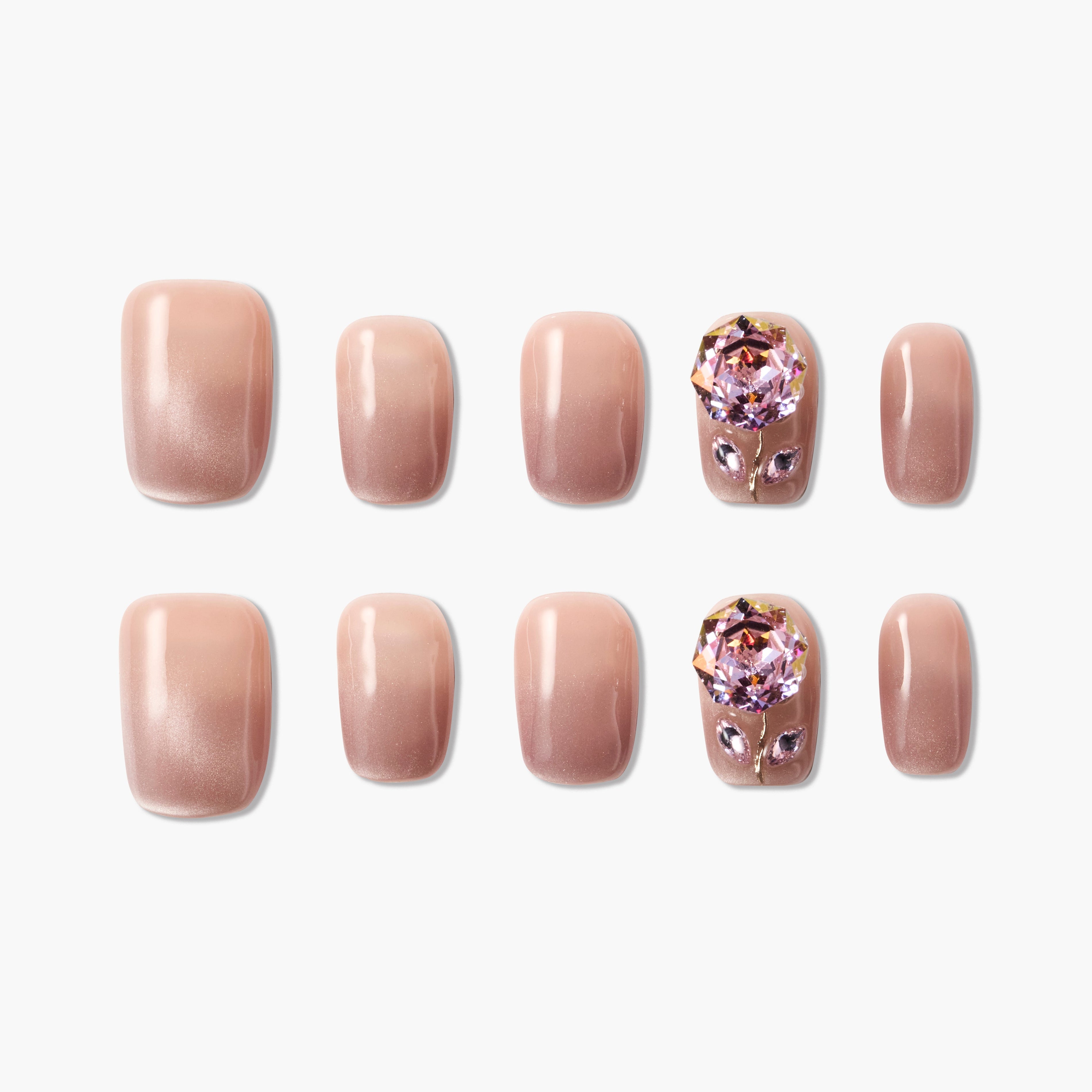 Nude pink press-on nails set with ombré finish and large pink crystal gem accents.