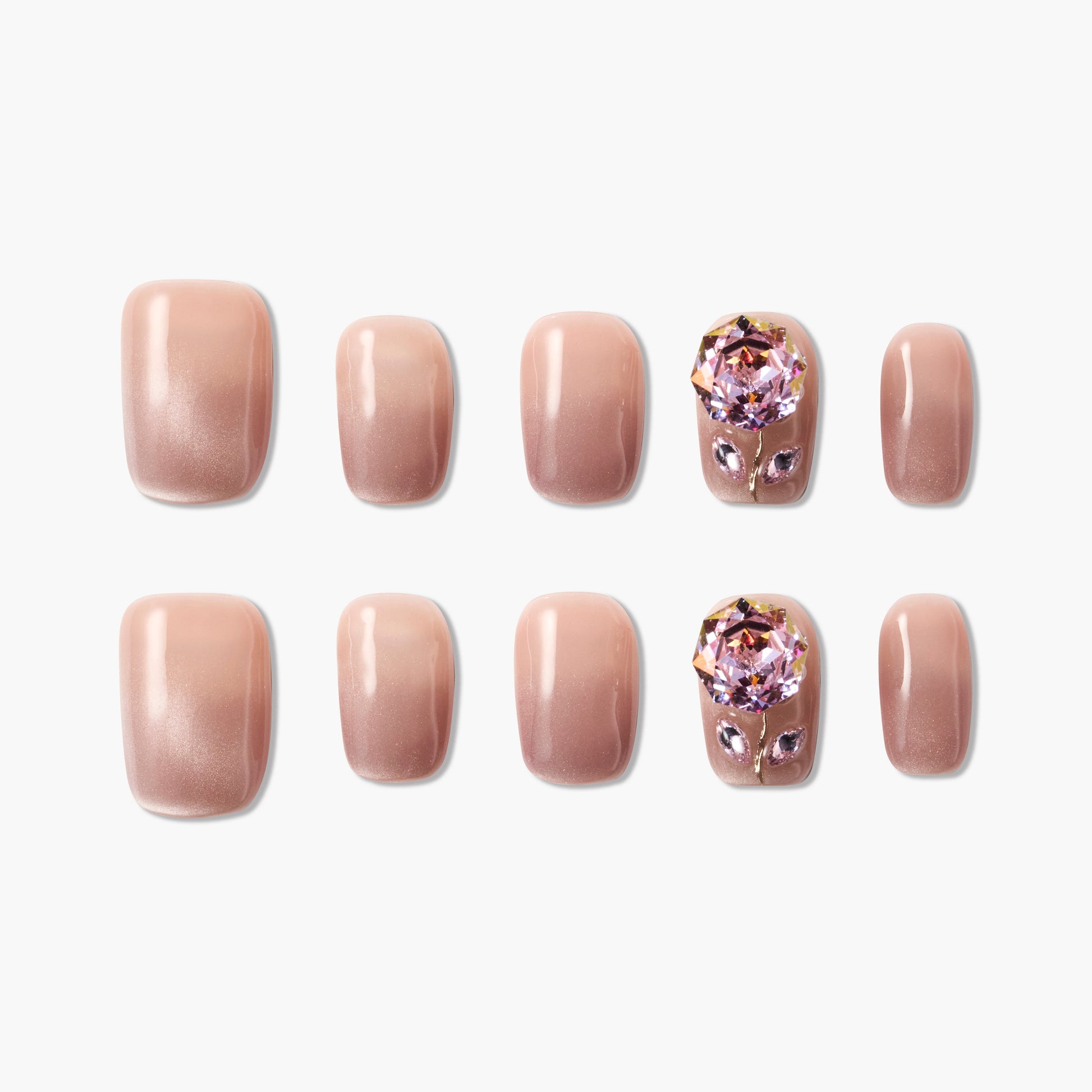 Nude pink press-on nails set with ombré finish and large pink crystal gem accents.