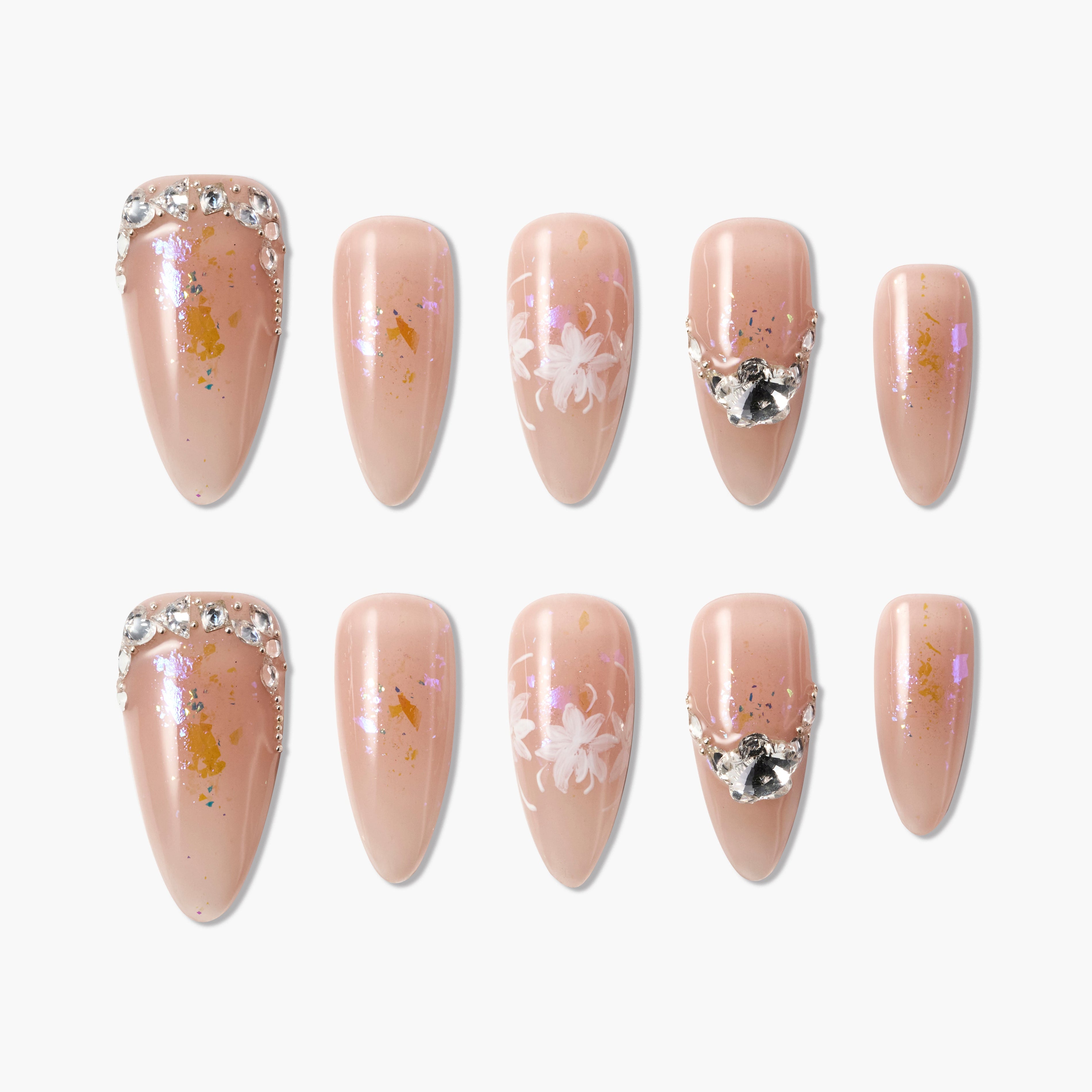 Handmade nude press-on nails with floral designs, gold foil, and rhinestone accents