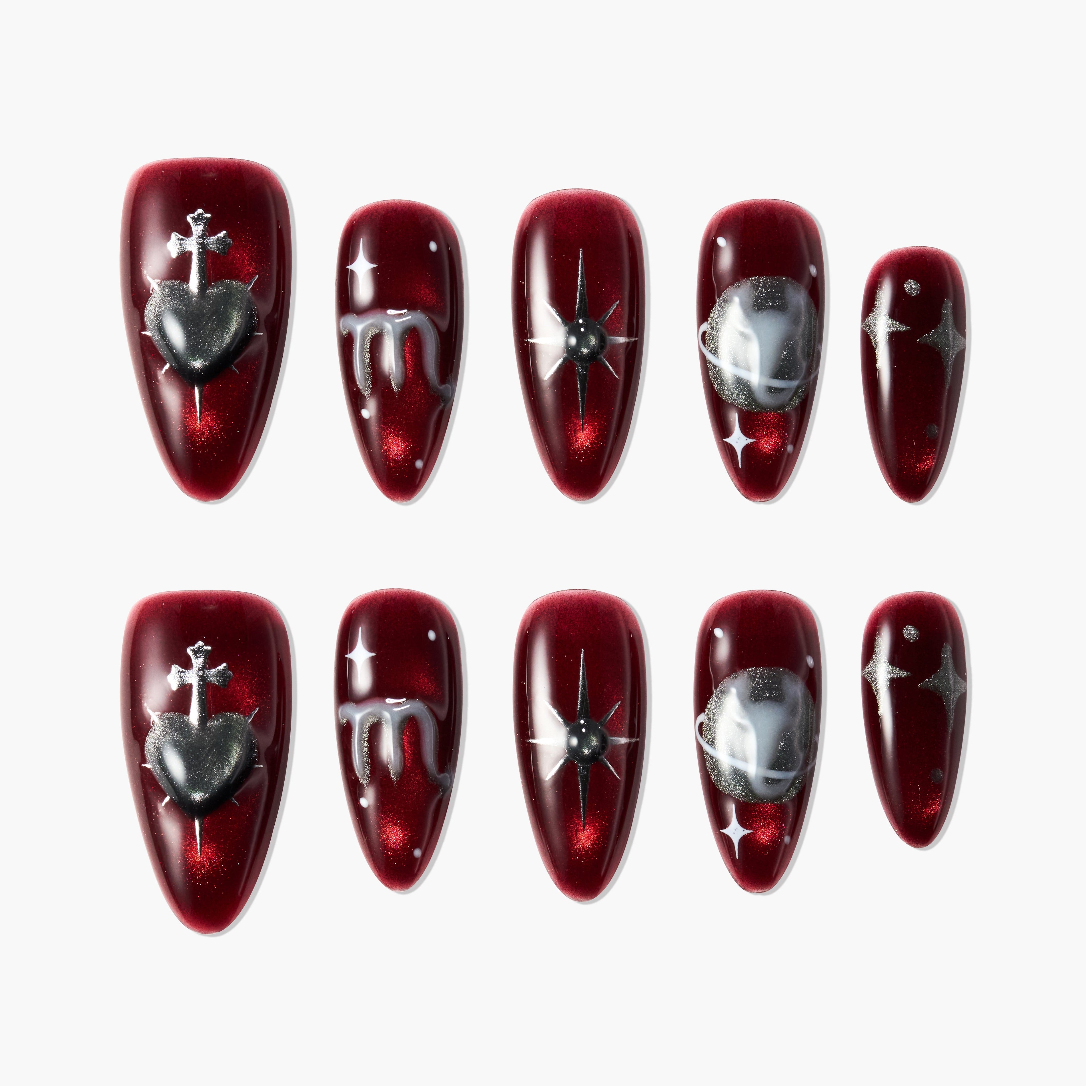 Glossy dark red press-on nails with silver heart, star, planet, and drip designs.