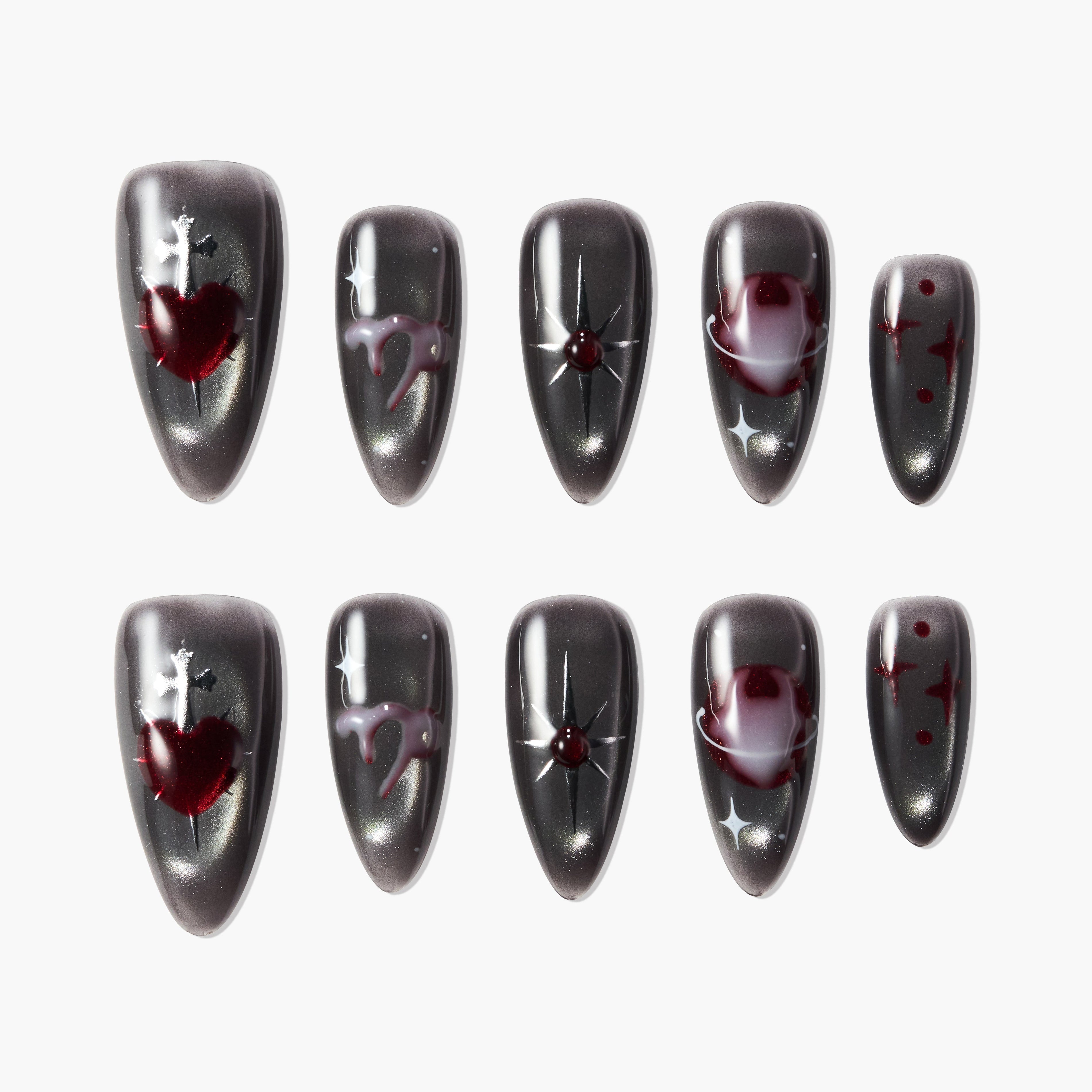 Handmade black press-on nails with red heart, star, and swirl designs, glossy finish