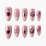 Set of pink glitter press-on nails with heart, star, and planet designs, ideal for nail art
