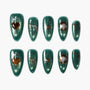 Green press-on nails with gold heart, star, marble, and drip designs, glossy finish.