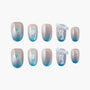 Blue ombre glitter press-on nails with 3D bow and abstract art accents, handmade design
