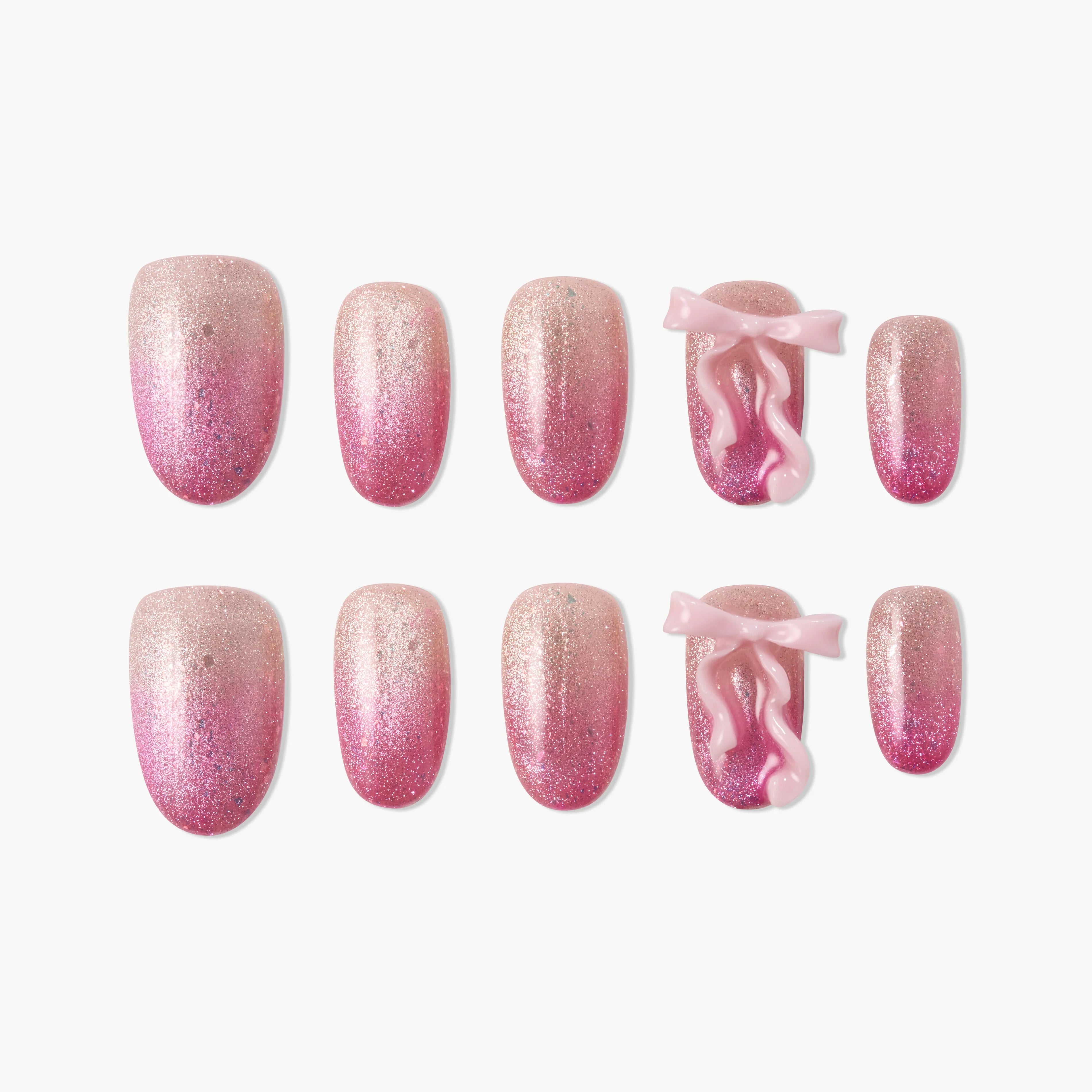 Handmade pink glitter press-on nails with 3D bow accents, ombre design, reusable set