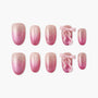 Handmade pink glitter press-on nails with 3D bow accents, ombre design, reusable set