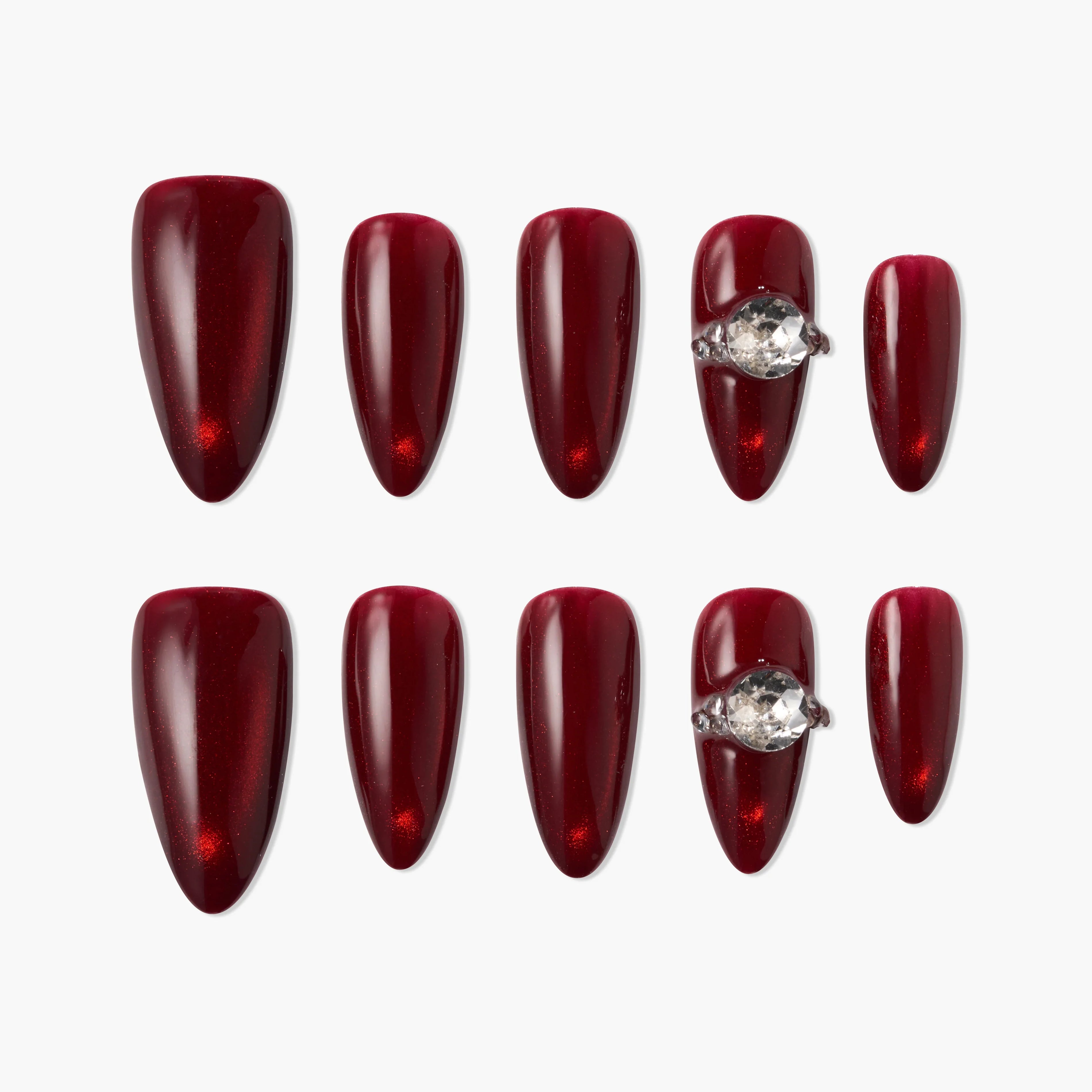 Handmade burgundy press-on nails with glossy finish and gemstone accent, arranged on white background
