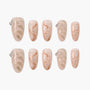 Handmade press-on nails with nude and gold marble design, glitter accents, and pearl rhinestones