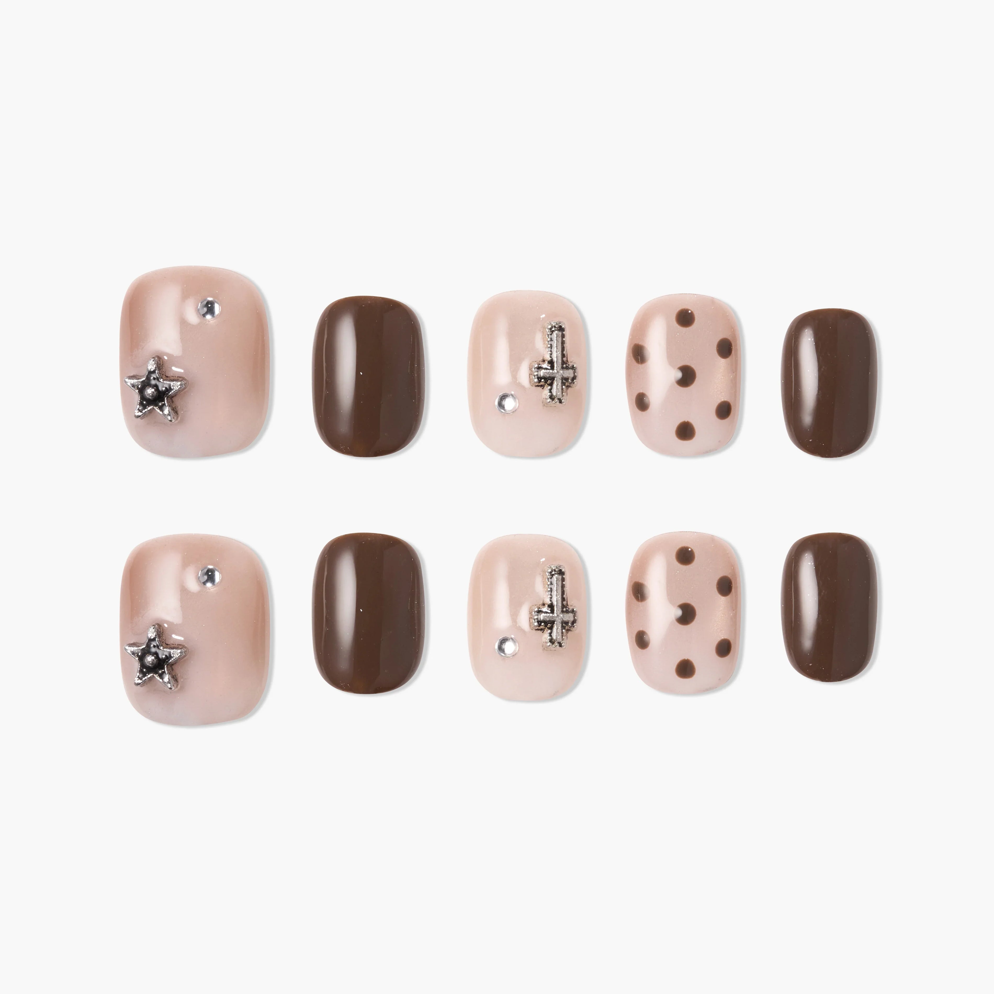 Handmade press-on nails in nude and brown with rhinestones, charms, and polka dot designs.