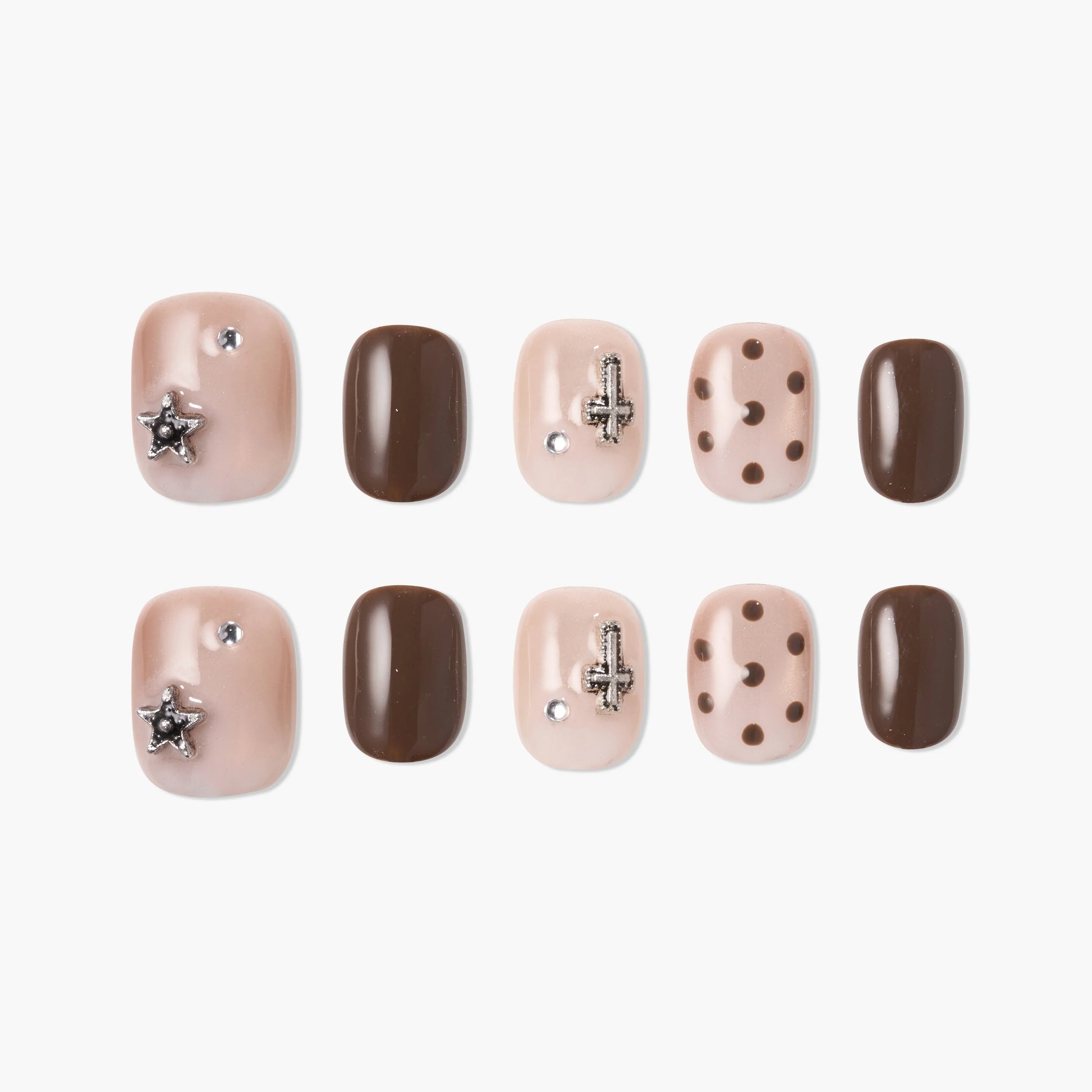 Handmade press-on nails in nude and brown with rhinestones, charms, and polka dot designs.