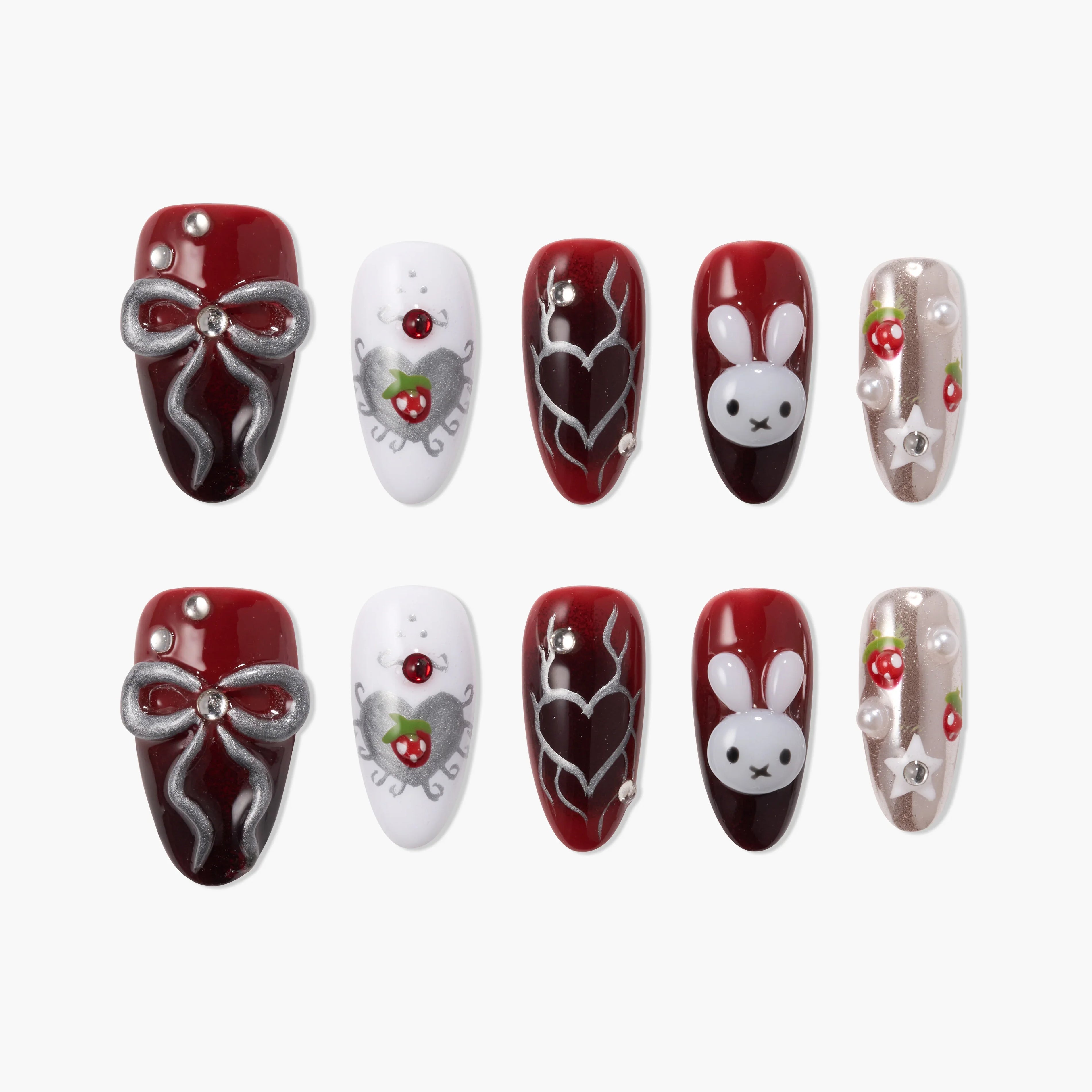 Handmade press-on nails with red, white, and silver designs, featuring bows, bunny faces, strawberries, and pearl accents.