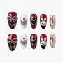 Handmade press-on nails with red, white, and silver designs, featuring bows, bunny faces, strawberries, and pearl accents.