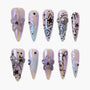 Handmade press-on nails with iridescent finish, 3D flowers, bows, stars, and gemstone accents