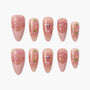 Pink press-on nails with glitter bows, bear, and strawberry designs, handmade nail art set
