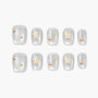 Handmade press-on nails with starfish and fish designs on a pearly white background