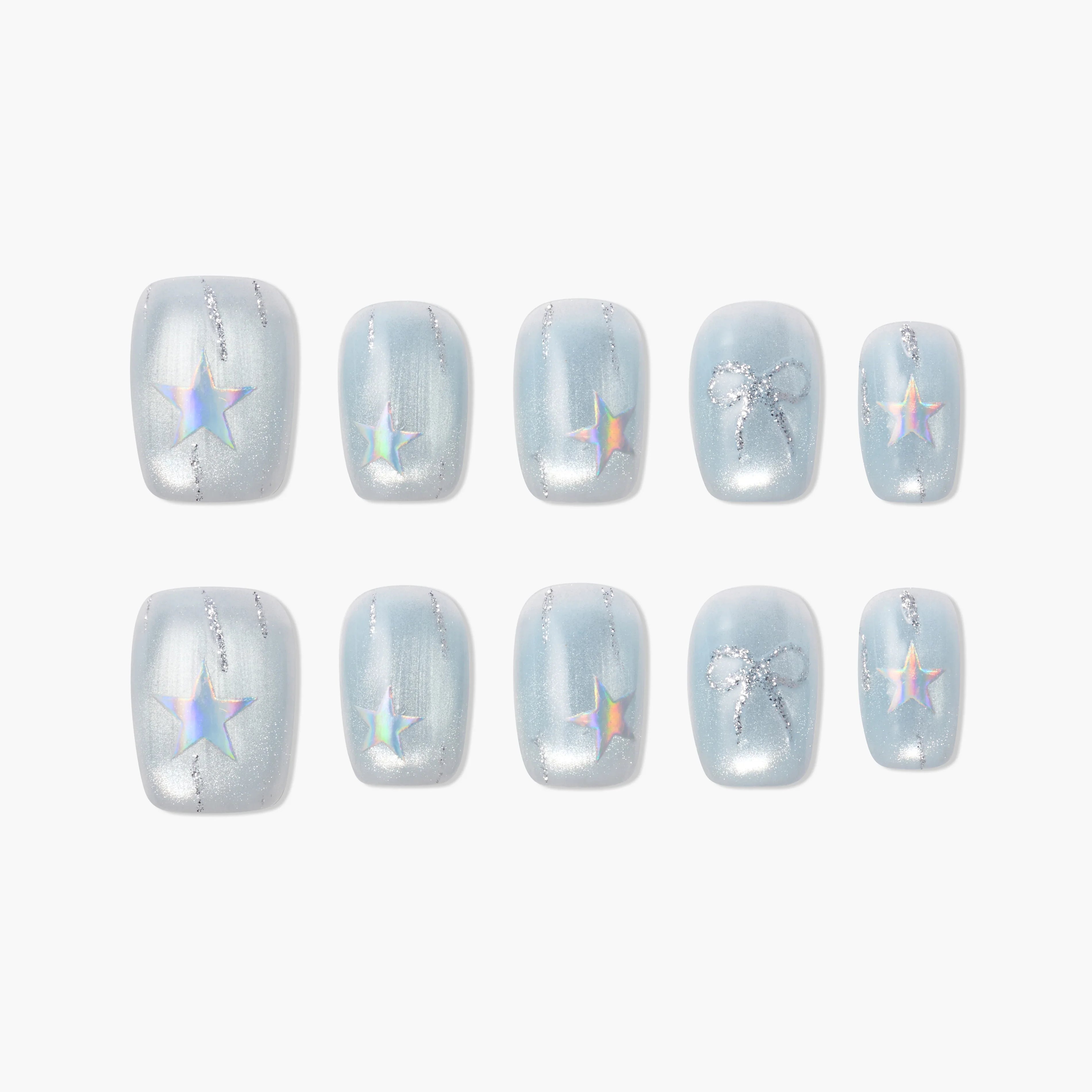 Handmade press-on nails with iridescent stars and silver glitter bows on pastel blue background