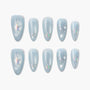 Handmade light blue press-on nails with holographic stars, bows, and glitter accents