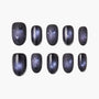 Handcrafted press-on nails with dark galaxy design, star accents, and glossy finish