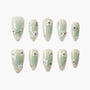 Handmade green press-on nails with pearl, floral, and rhinestone 3D embellishments
