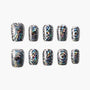 Holographic press-on nails with black and silver geometric patterns arranged on white background