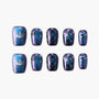 Galaxy-themed press-on nails with blue and purple shimmer, stars, plaid, and constellation designs