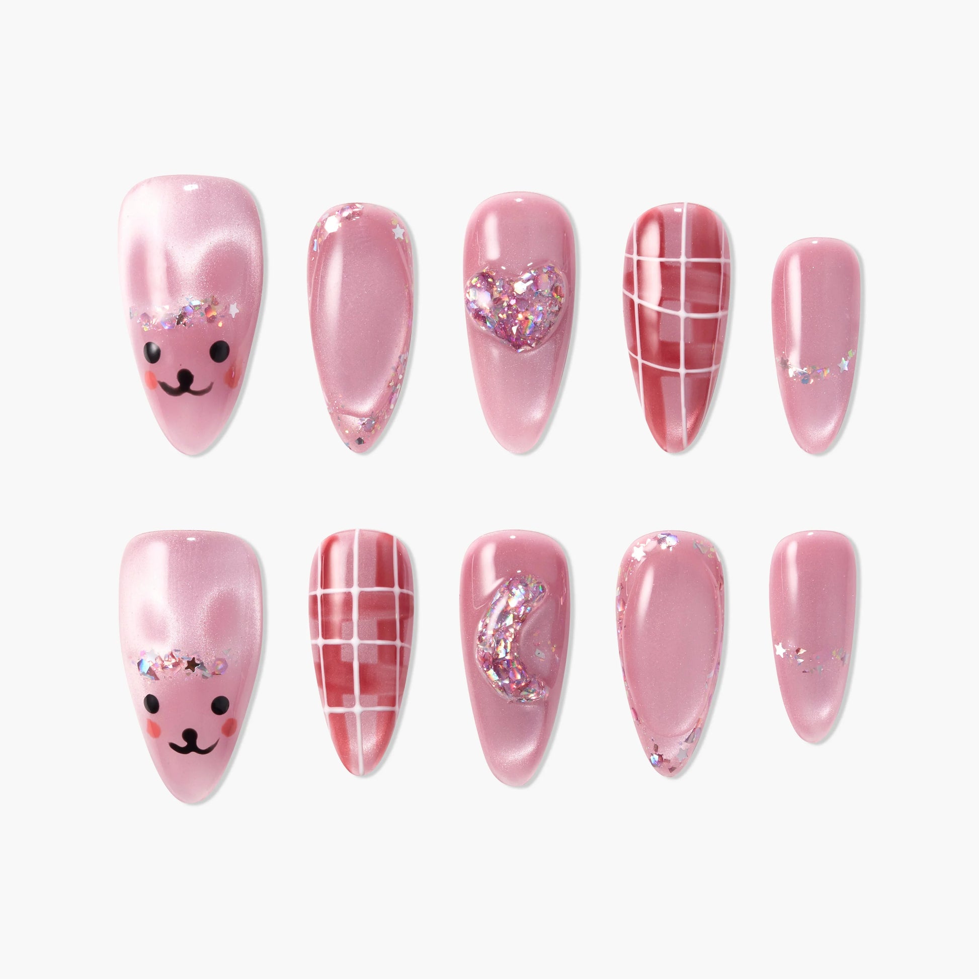 Pink press-on nails with bear faces, glitter, heart, moon, and plaid designs.