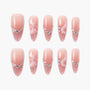Pink ombre press-on nails with rhinestones and 3D floral accents, almond shape set.