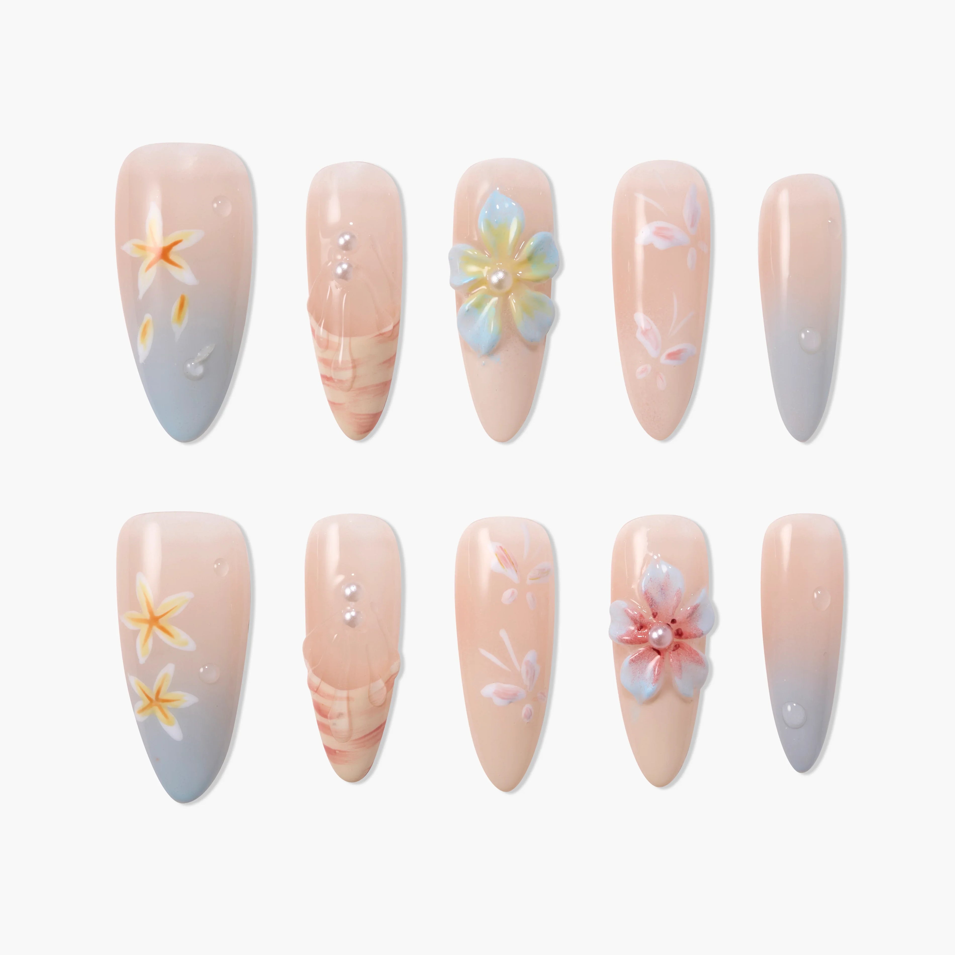 Floral press-on nails with pastel designs, pearl accents, and gradient nude to blue tips