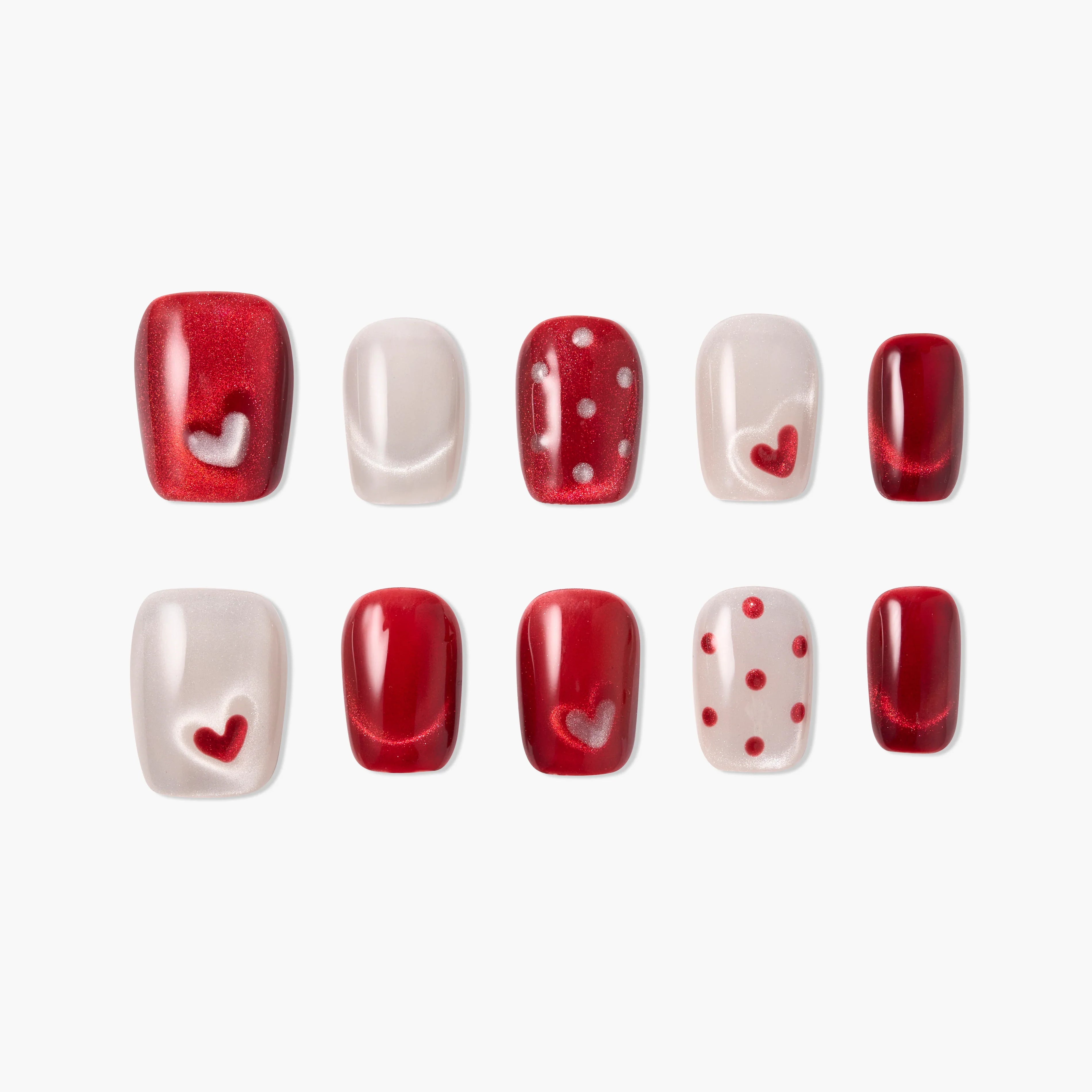 Handmade press-on nails in red and pearl with heart and polka dot designs, glossy finish