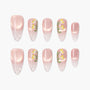 Pink ombre press-on nails with yellow floral design and clear tips, arranged on white background