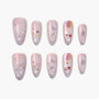 Handmade press-on nails with pink base, silver star outlines, rainbow stripes, and colorful star decals.