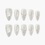 Handmade press-on nails with silver glitter tips, rhinestones, and pearl accents, elegant design