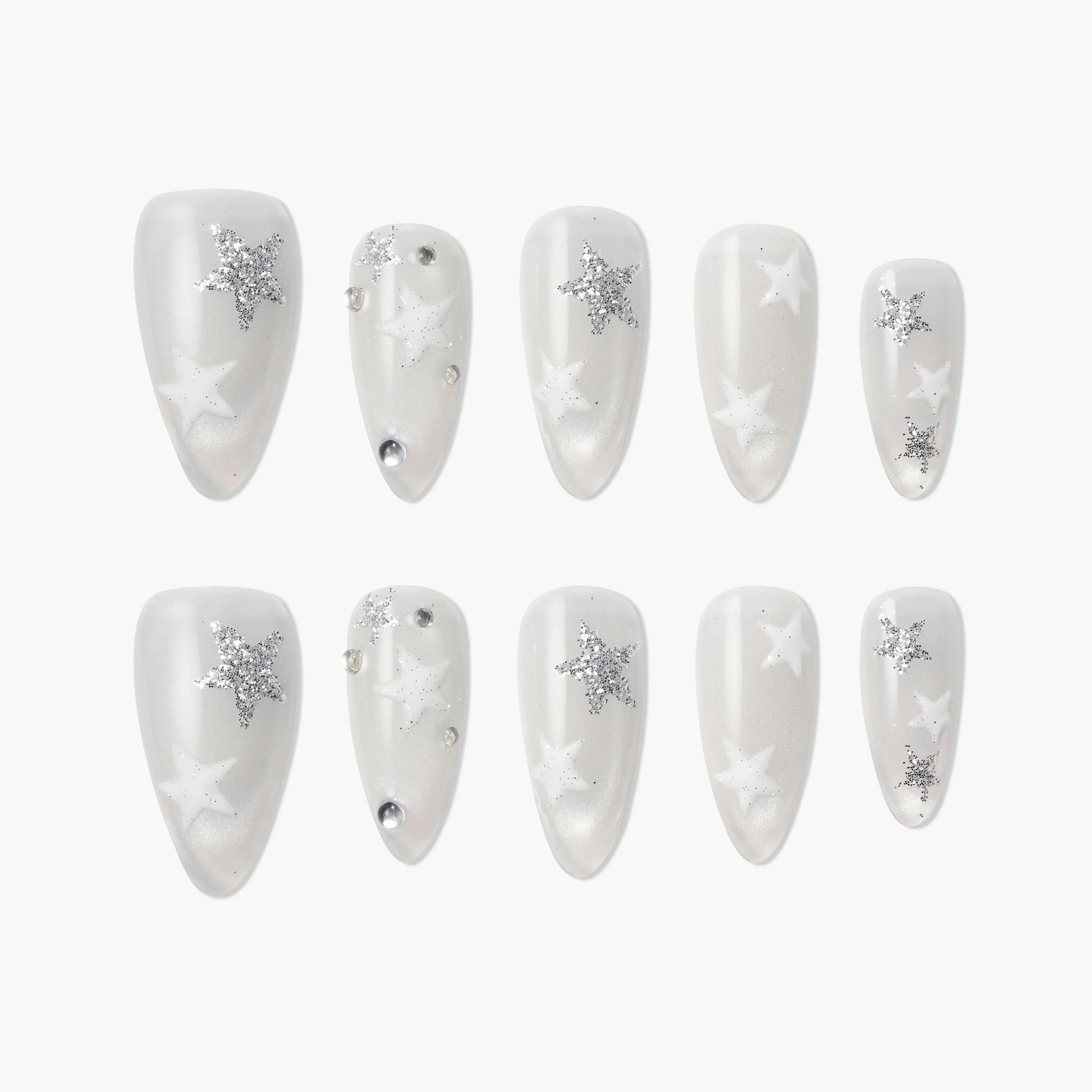 White press-on nails with silver glitter star designs, pearl finish, and rhinestone accents.