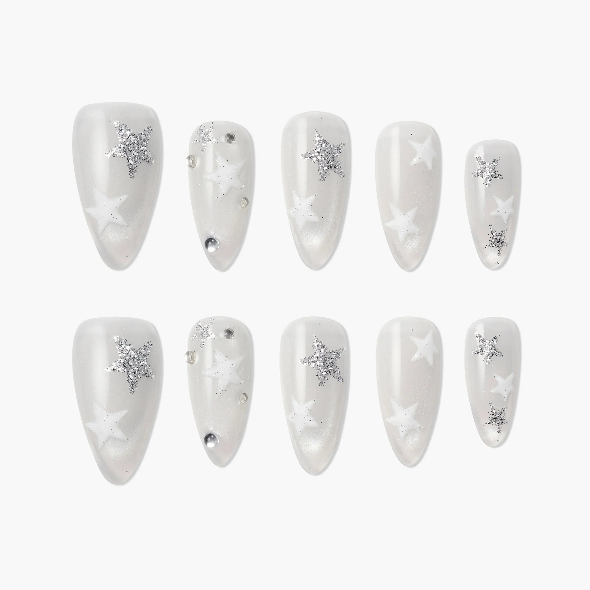 White press-on nails with silver glitter star designs, pearl finish, and rhinestone accents.