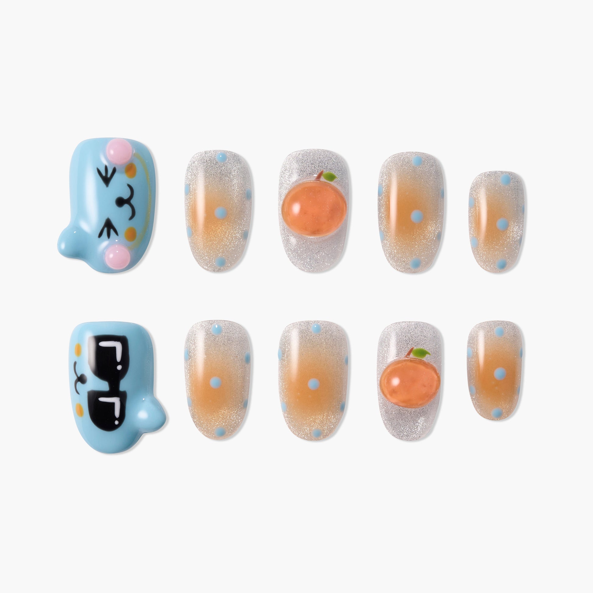 Handmade press-on nails set with cartoon faces, peach accents, and blue polka dot design.