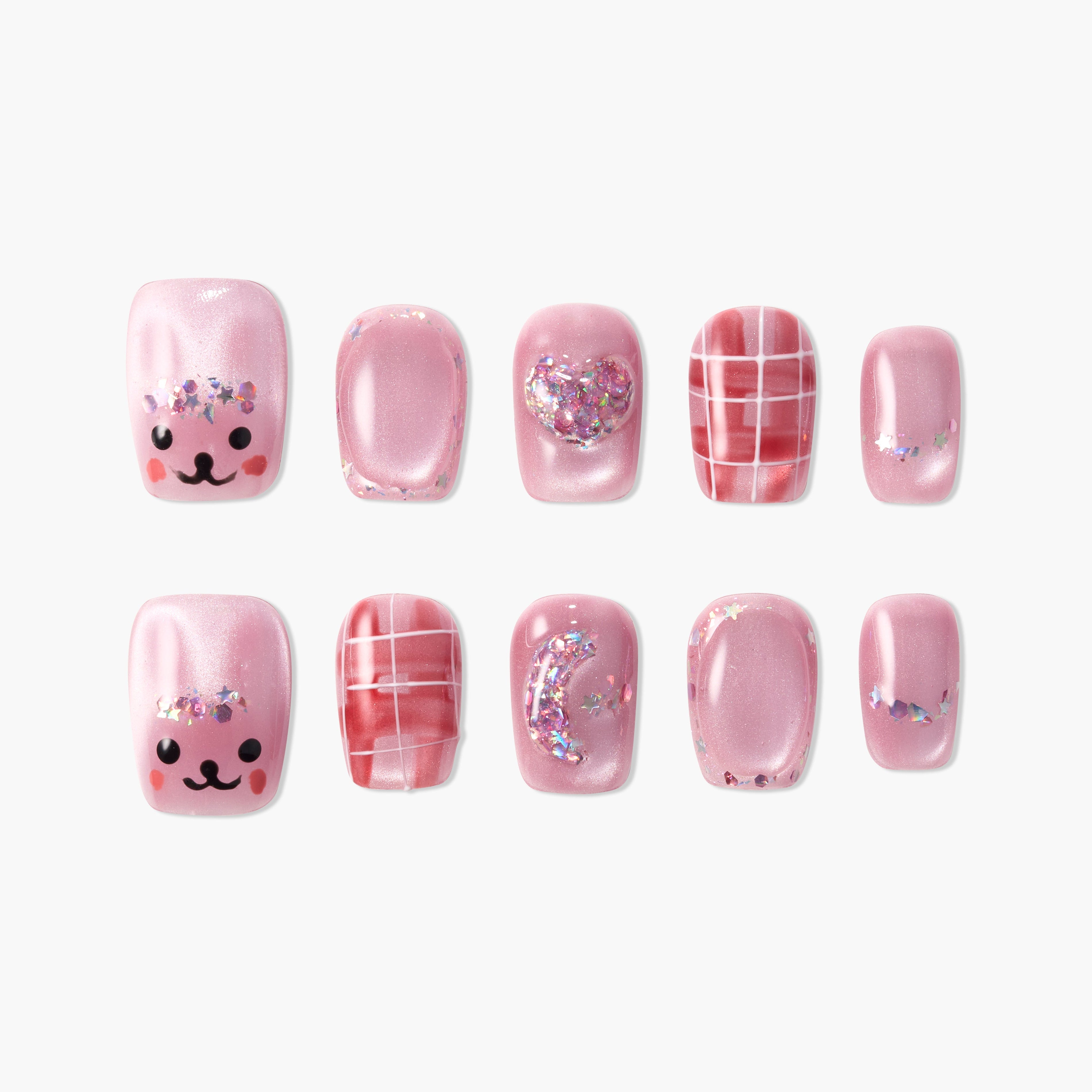 Handmade pink press-on nails with glitter, plaid, heart, and cute face designs on white background.