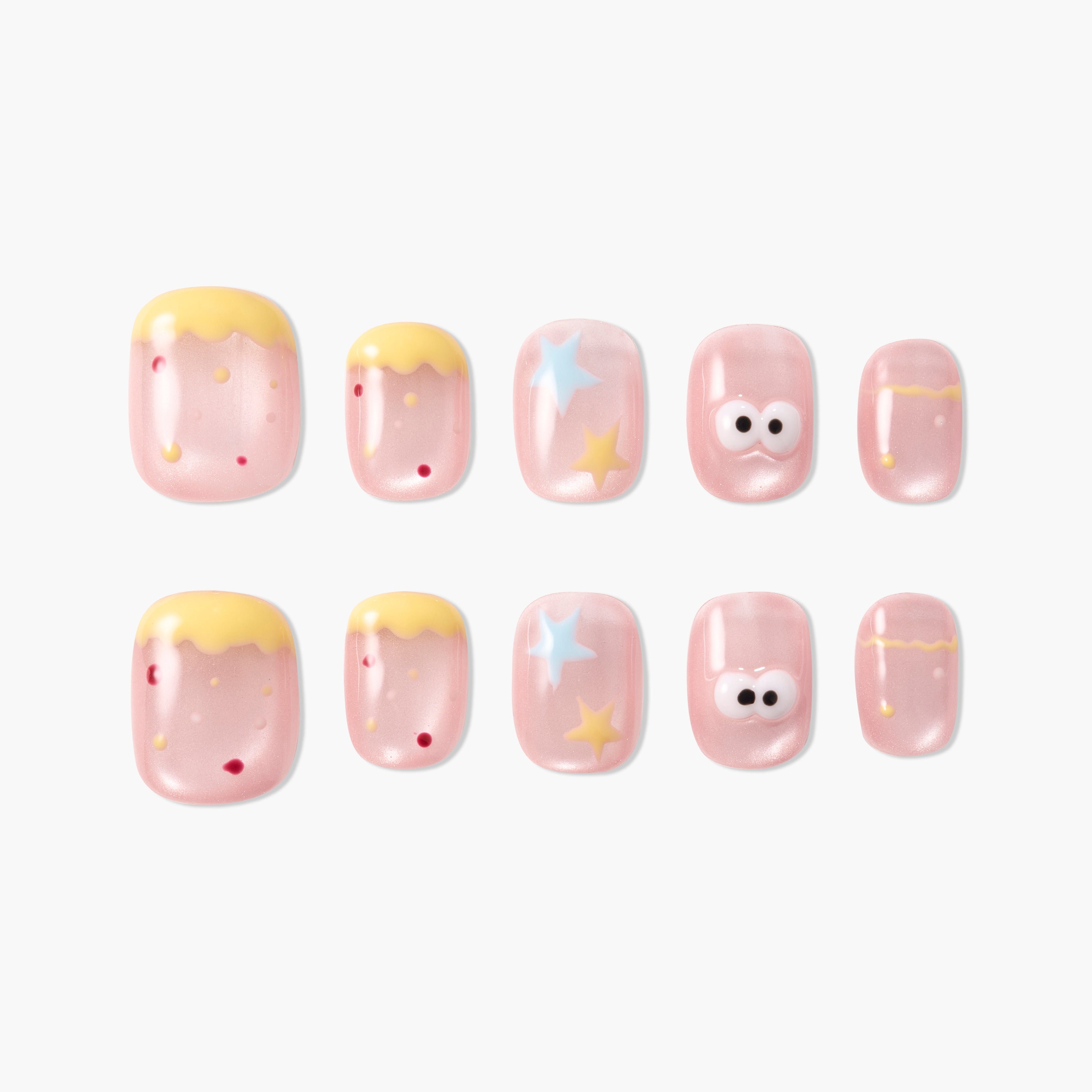 Cute pink press-on nails with yellow tips, stars, red dots, and cartoon eye designs