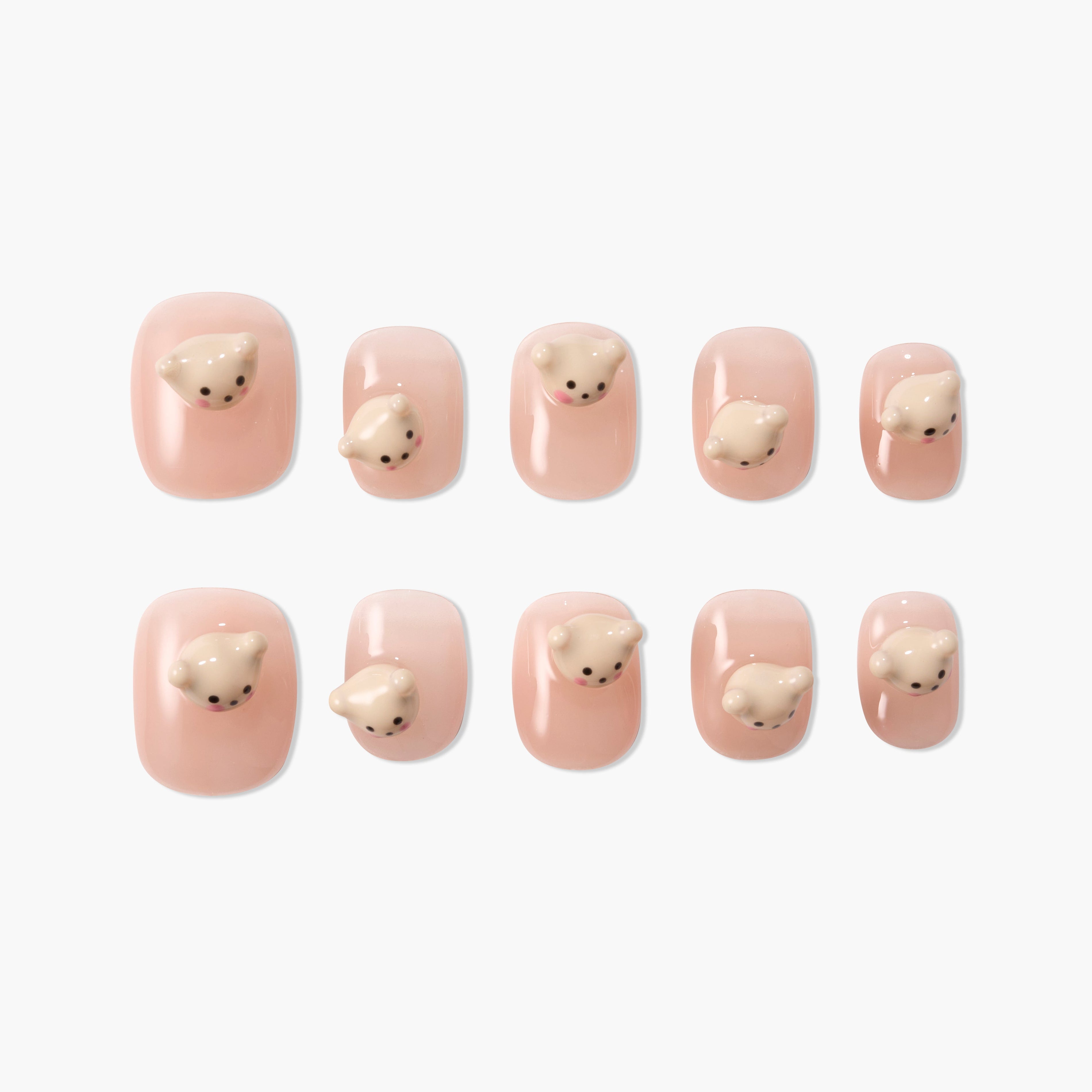 Handmade press-on nails with nude pink base and 3D bear face accents, cute nail art set