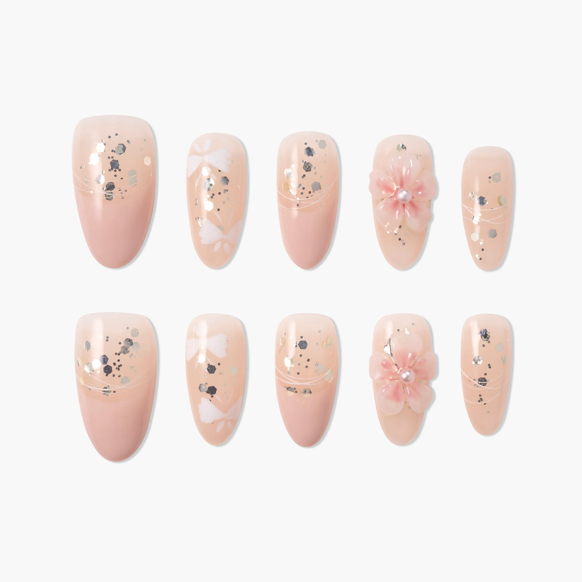 Handmade press-on nails in nude pink with glitter, white accents, and 3D floral design