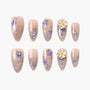 Handmade press-on nails with nude base, purple and gold floral designs, 3D flower accents