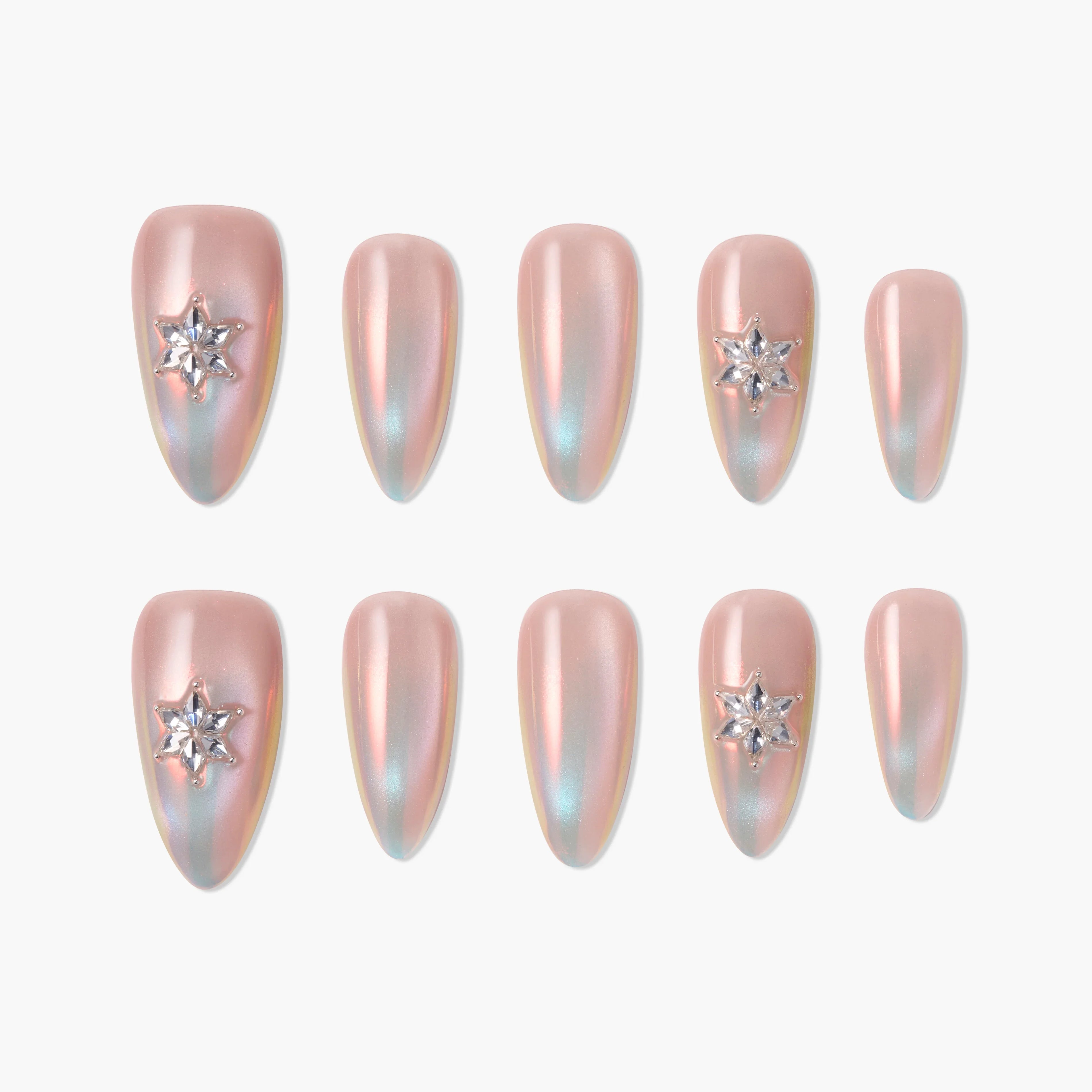 Iridescent pink almond press-on nails with star rhinestone accents, set on a white background