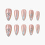 Iridescent pink almond press-on nails with star rhinestone accents, set on a white background