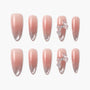 Pink ombre press-on nails with silver glitter and 3D bow accents, displayed on white background