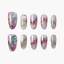 Set of handmade press-on nails with marble design in pink, green, and metallic silver.