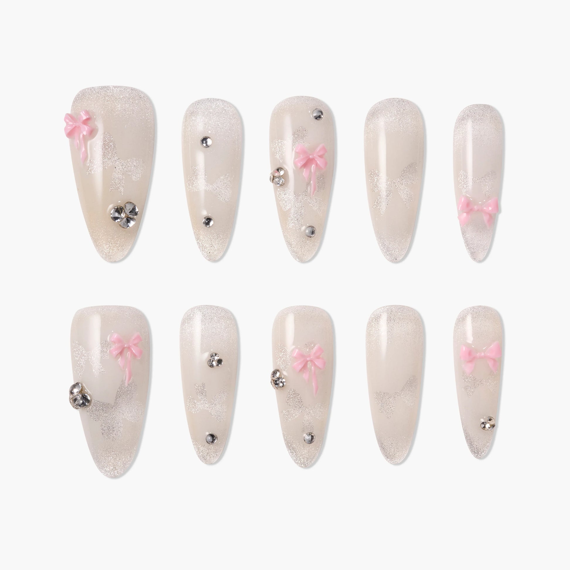 Handmade press-on nails with pale glitter, pink bows, and rhinestone accents, arranged in two rows