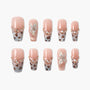 Handmade press-on nails with pink base, leopard print tips, rhinestones, and 3D floral accents