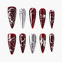 Handmade press-on nails in burgundy and silver with star, swirl, and gem designs