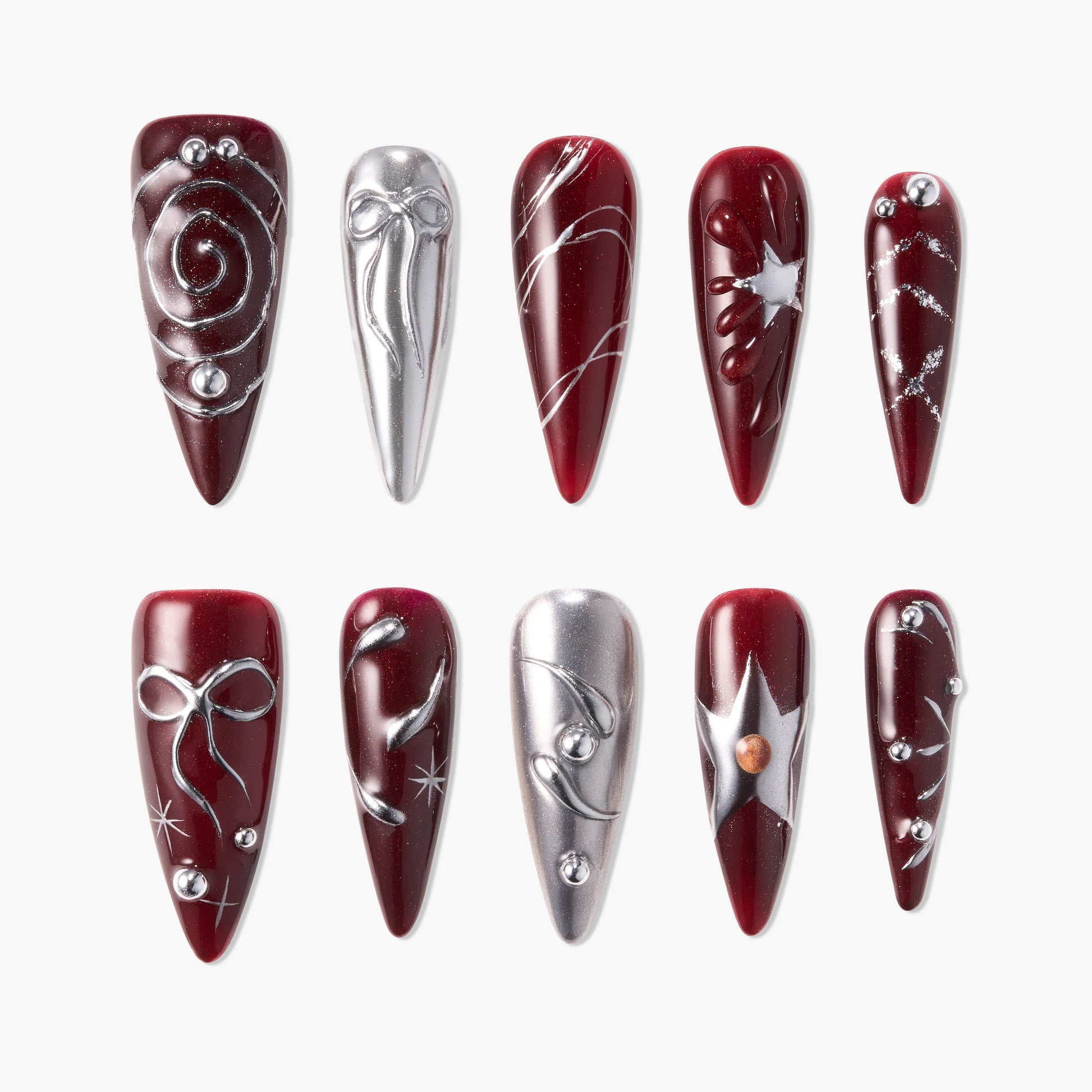 Handmade press-on nails in burgundy and silver with star, swirl, and gem designs
