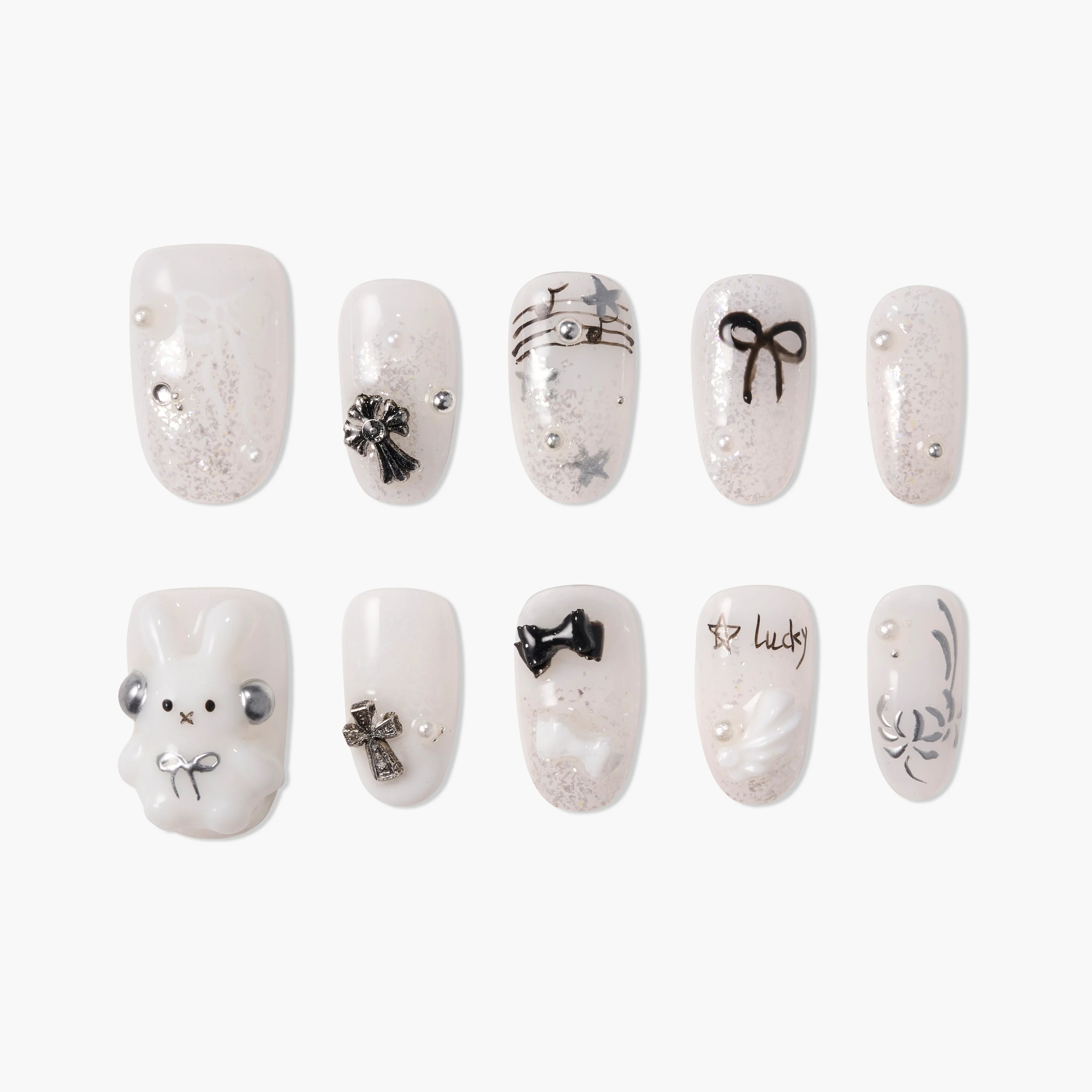 Cute white and silver press-on nails with black bows, stars, pearls, and 3D bunny design.